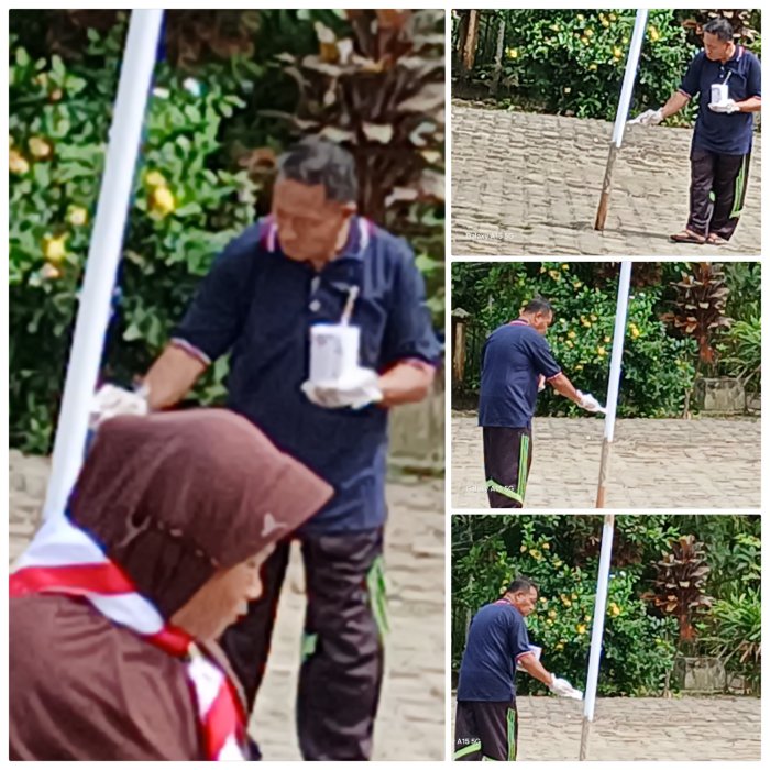 Staf MIN 2 Muaro Jambi Cat Ulang Tiang Voli Lapangan